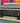 Epson large-format printer with a colorful abstract painting in the background